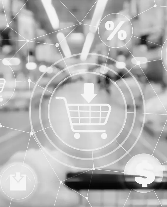 A digital shopping trolley icon with network lines and symbols, such as a percentage and pound sign, overlays a blurred supermarket aisle in black and white.