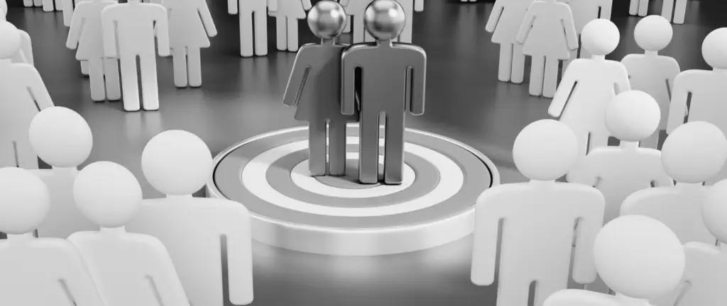 Metallic male and female figures stand together on a target, surrounded by white, featureless human figures in a circle. The scene appears to be in black and white, reminiscent of the precision and focus described in A guide to keywords in SEO.