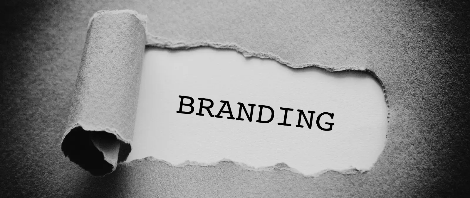 a tear in paper that reveals the word branding