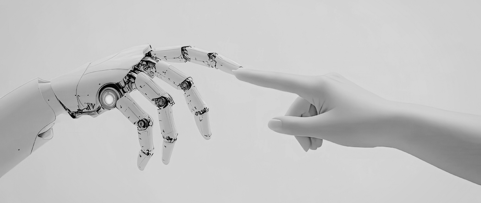 A hand reaching out to touch a robotic hand.