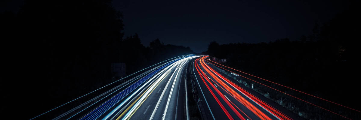 Long exposure of cars on a highway at night.
