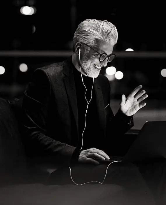 man on a business call using his laptop